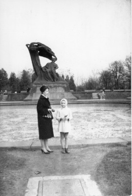Kobieta z dziewczynką stojące przed pomnikiem Chopina.