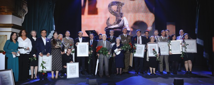 Laureaci nagrody "Wawa Bohaterom" stoją na scenie, trzymając dyplomy i nagrody. 