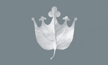 Logo Łazienek Królewskich przedstawiające liść zakończony na kształ korony. 
