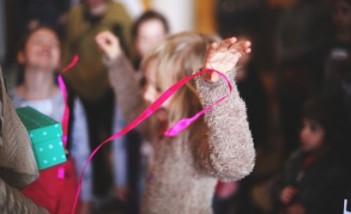 Dziecko tańczy z kolorową wstążką. 